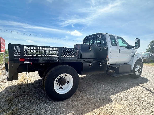 Flatbed truck with added side rails and toolboxes