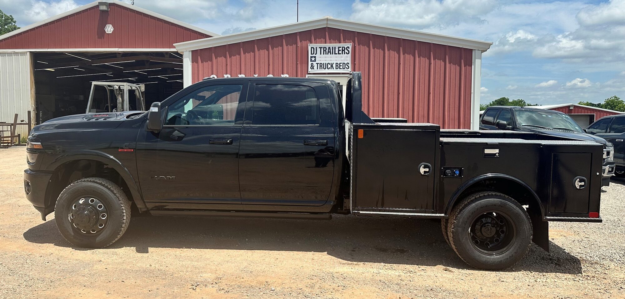 Black Ram truck with a CM TM Deluxe body outside the DJ FleetWorX shop